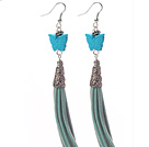 Long style de forme de papillon bleu turquoise balancent des boucles d'oreille en cuir de gland avec le gland en cuir