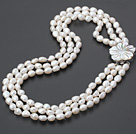 three strand white pearl necklace with shell clasp