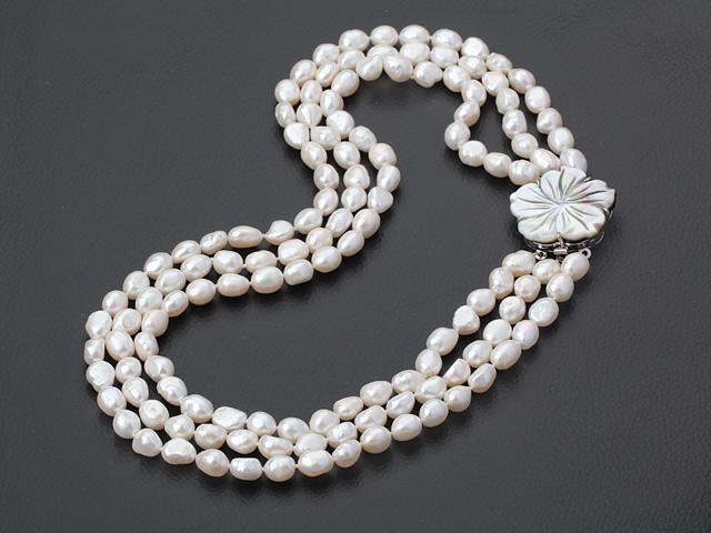 three strand white pearl necklace with shell clasp