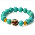 Popular Xinjiang Green Turquoise And Beeswax Beads Stretch Bracelet With Tibetan Charm