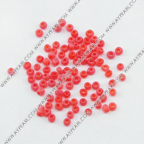 Glass seed beads, opaque red, 2.5mm round. Sold per pkg of 450 grams.