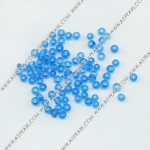 Glass seed beads, transparent blue, 2.5mm round. Sold per pkg of 450 grams.