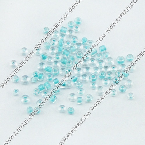 Glass seed beads, transparent inside blue, 2.5mm round. Sold per pkg of 450 grams.