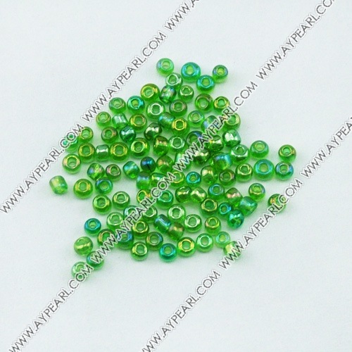 Glass seed beads, transparent rainbow green , 2.5mm round. Sold per pkg of 450 grams.