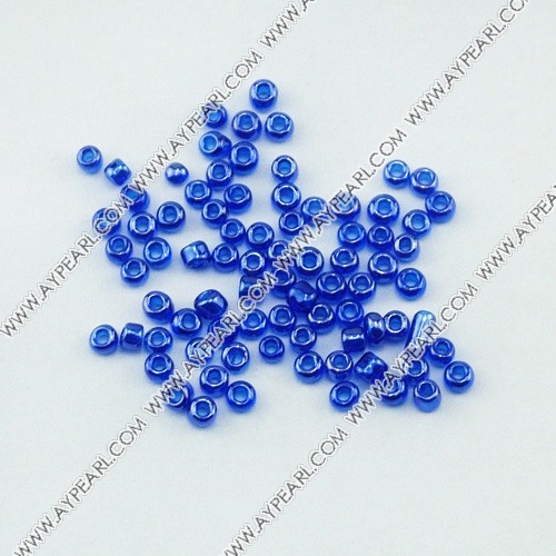 Glass seed beads, transparent lustered blue, 2.5mm round. Sold per pkg of 450 grams.