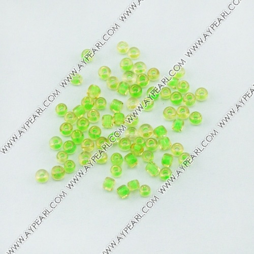 Glass seed beads, transparent inside green and yellow, 2.5mm round. Sold per pkg of 450 grams.