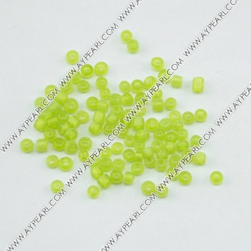 Glass seed beads, transparent green , 2.5mm round. Sold per pkg of 450 grams.