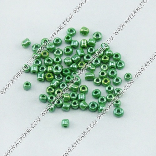 Glass seed beads, opaque lustered green, 2.5mm round. Sold per pkg of 450 grams.