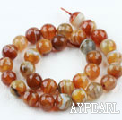 Agate gemstone beads, orange, 12mm streaked faceted round. Sold per 15.16-inch strand.