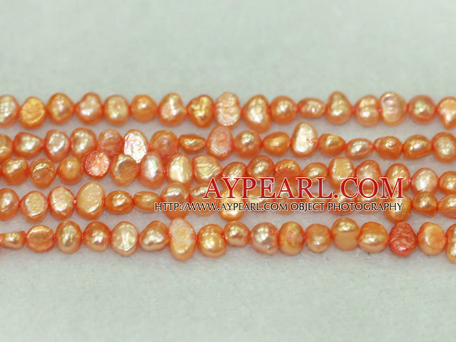 Freshwater pearl beads, dyed light orange, 5-6mm potato. Sold per 14-inch strand.